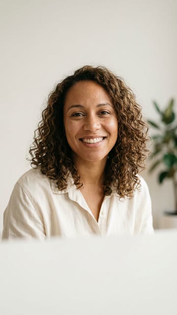 A generated character: a founder in her thirties, lit by a window